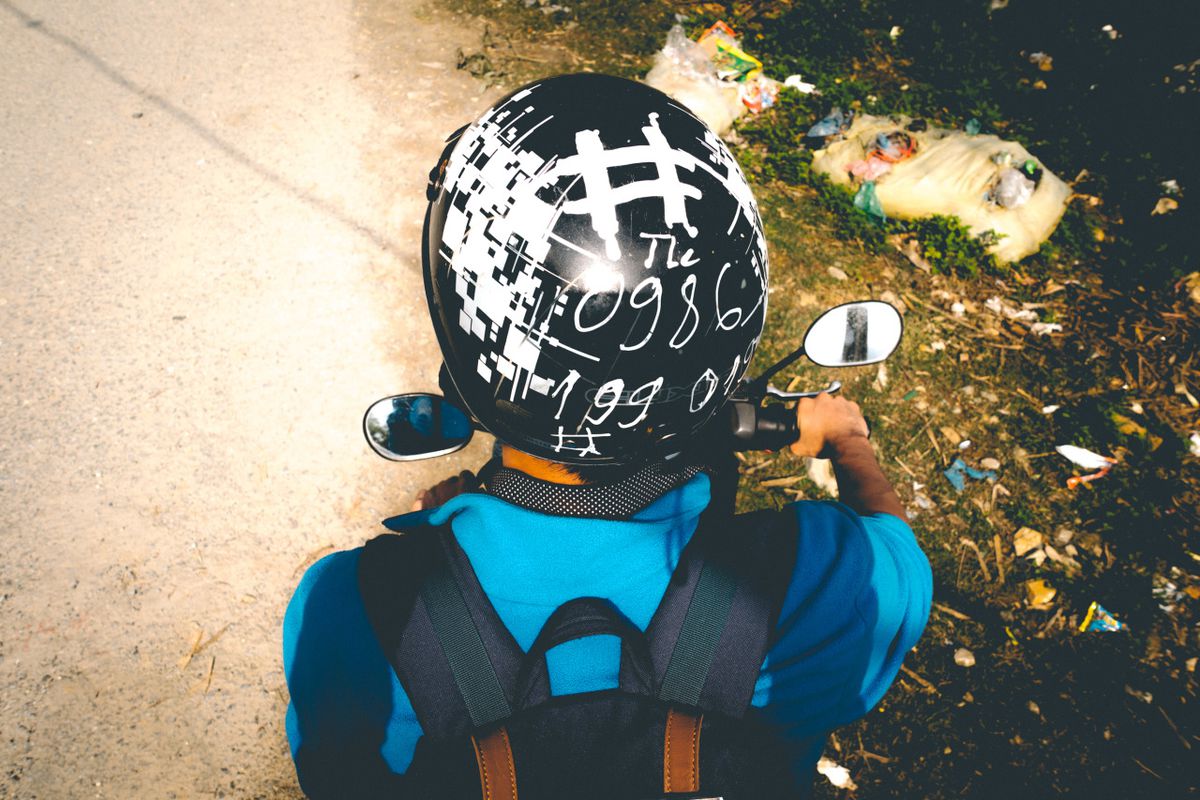 A motorbike helmet on a traveler riding a motorbike in Sapa