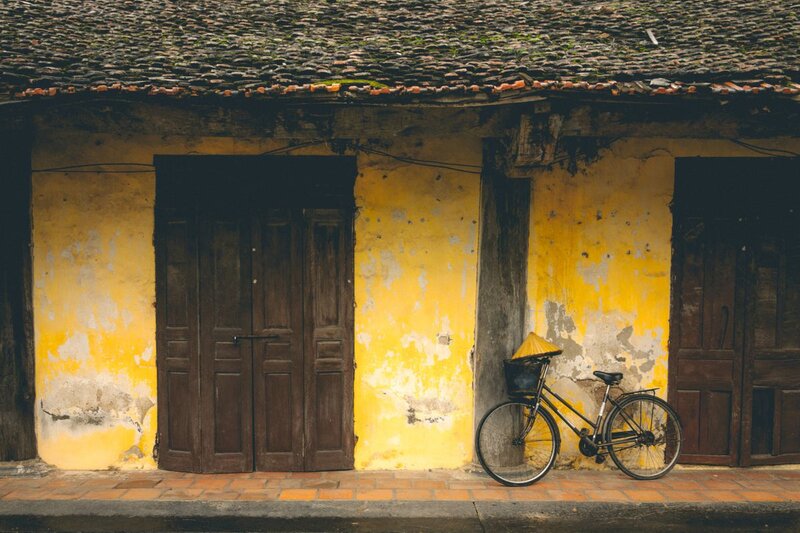 a bike parked in front of a yellow building in Ninh Binh