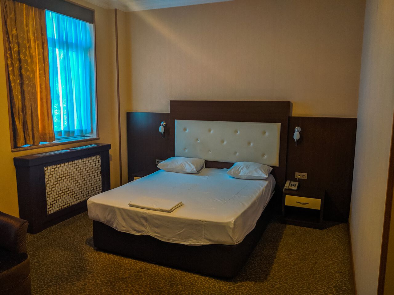 The bed and the spacious room at Grand Nakhchivan Hotel