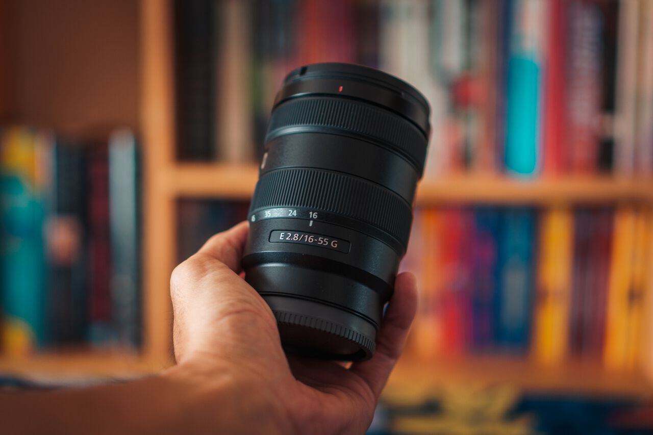 A man holding the Sony 16-55mm F2.8 Lens