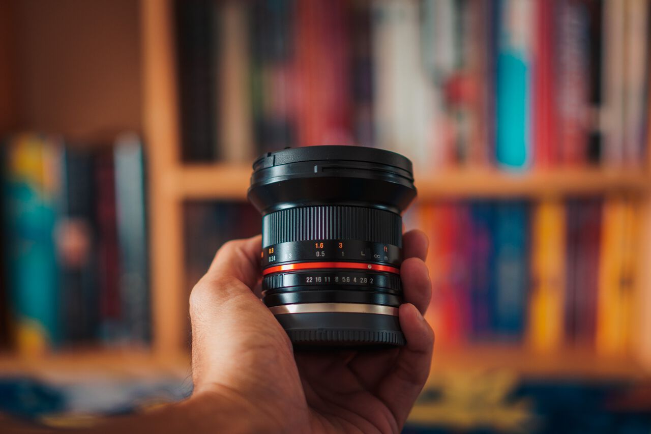 A man holding the Rokinon 12mm F2