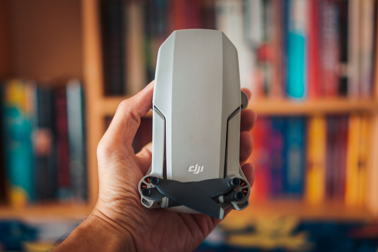 A man holding the DJI Mavic Mini drone
