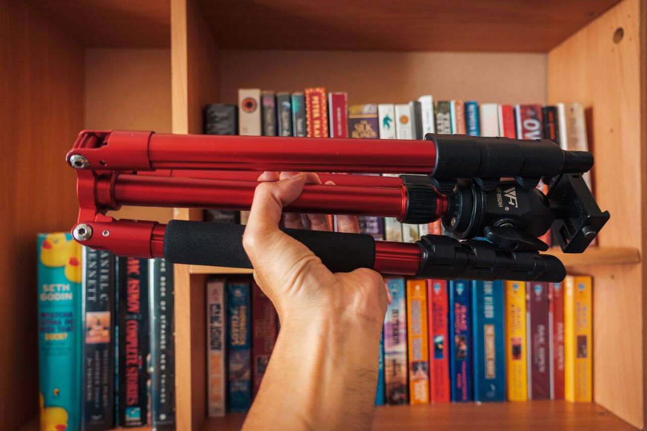 A man holding a light-weight travel tripod
