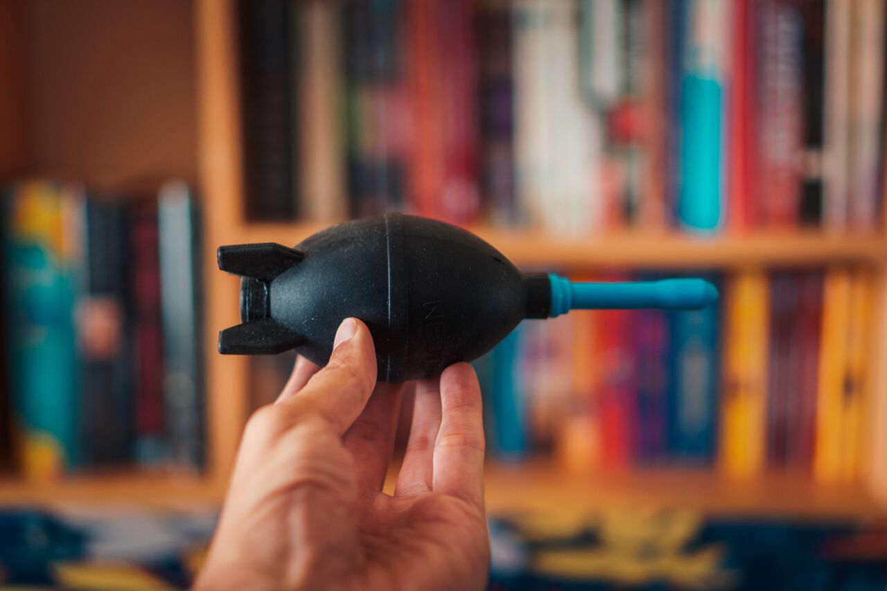 A man holding an air blower