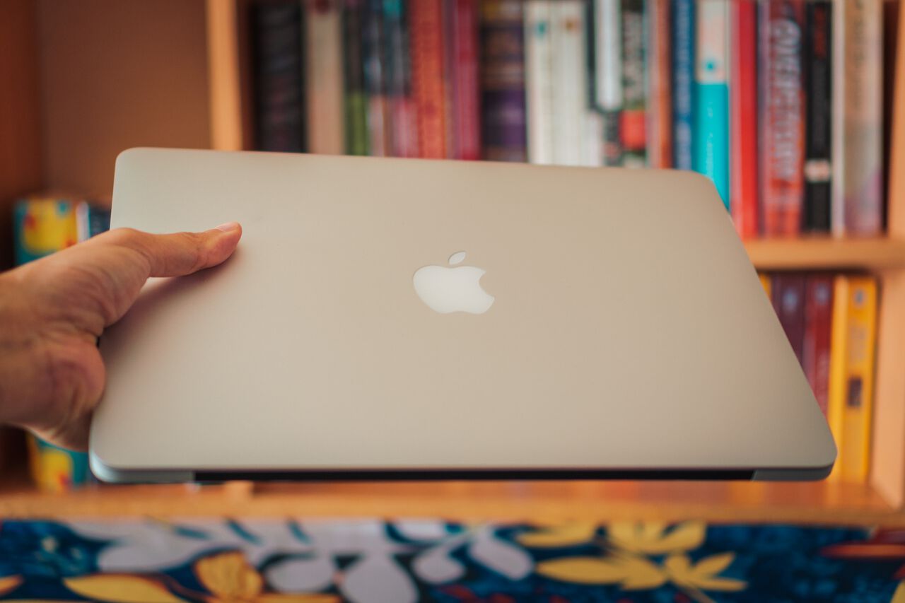 A man holding a 13 inch MacBook Pro 2015