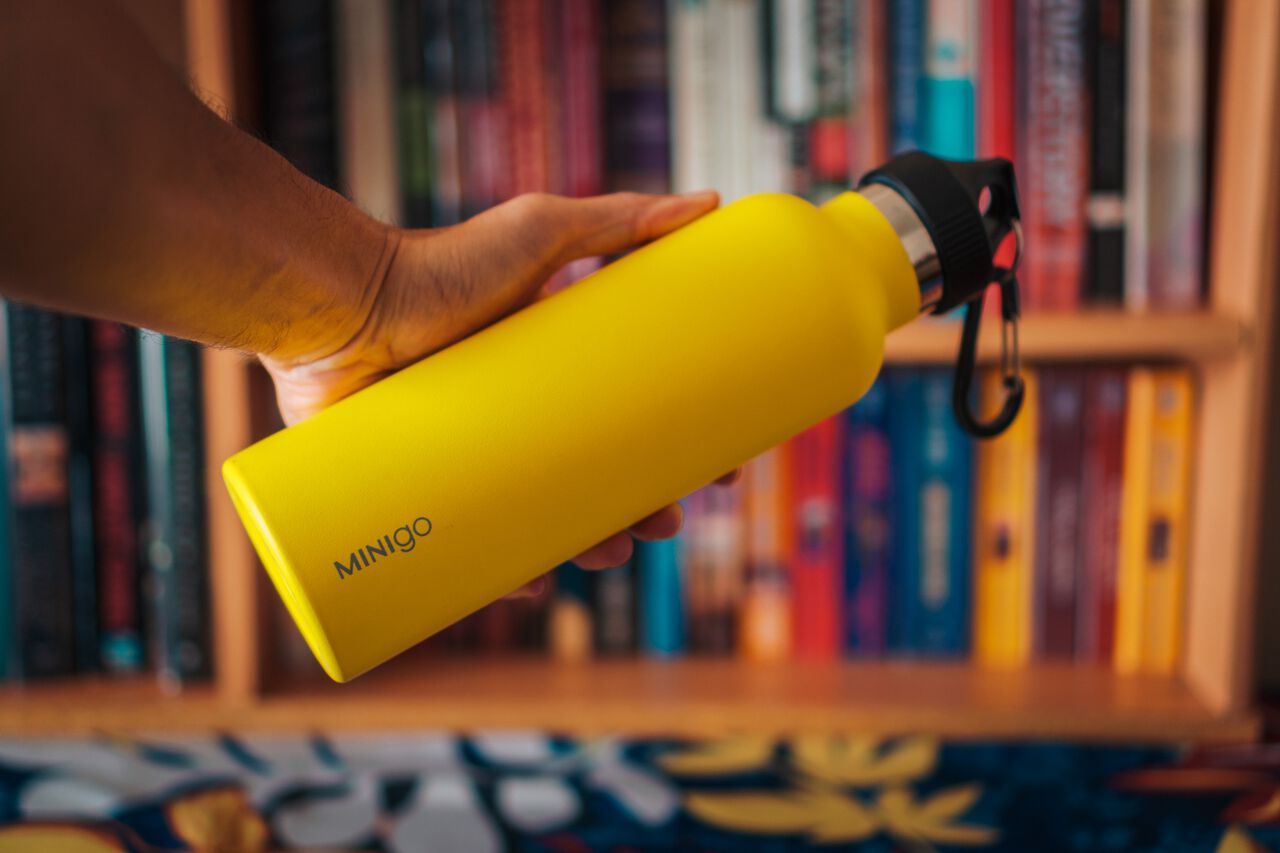 A man holding a yellow water bottle.