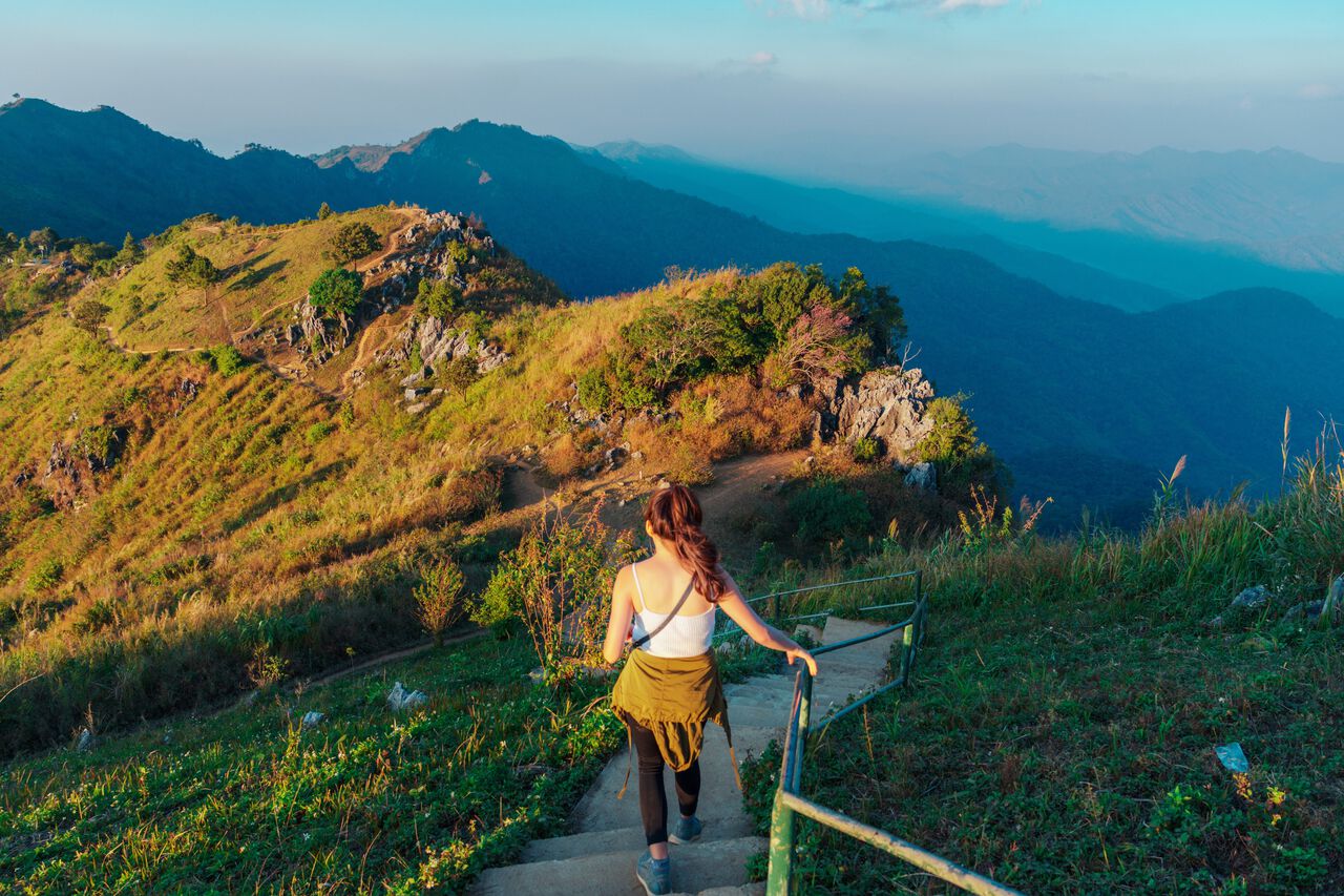 A woman hiking down from Doi Pha Tang in Chiang Rai