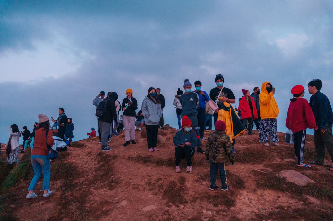 Crowds gathering at the top of Phu Chi Fa at sunrise in Chiang Rai