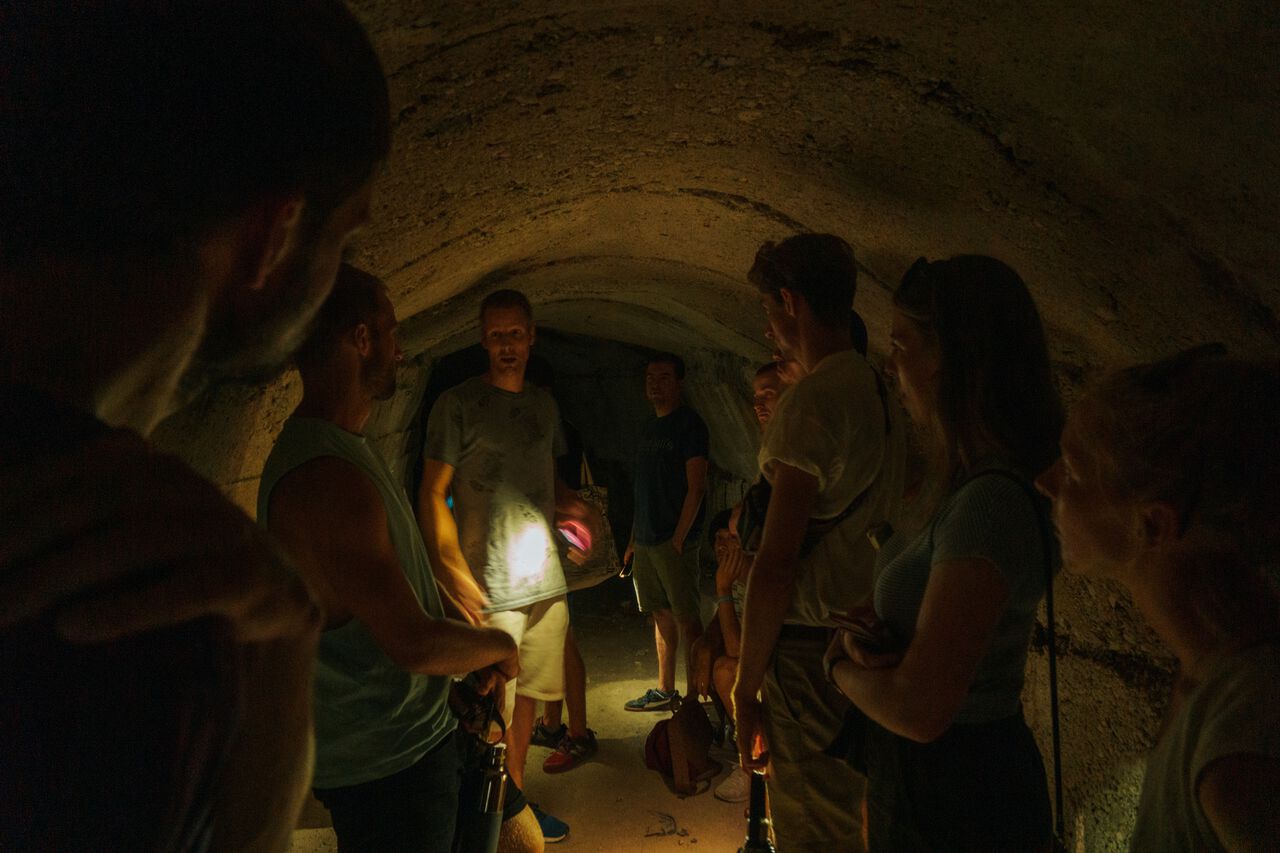 People on a free walking tour in a bunker in Gjirokaster, Albania