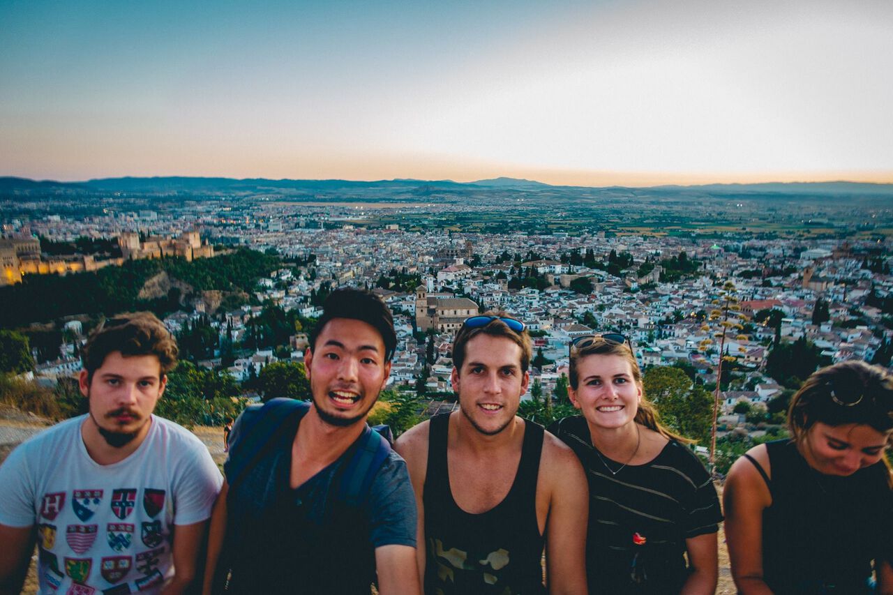 A group of people taking selfies in Granada, Spain