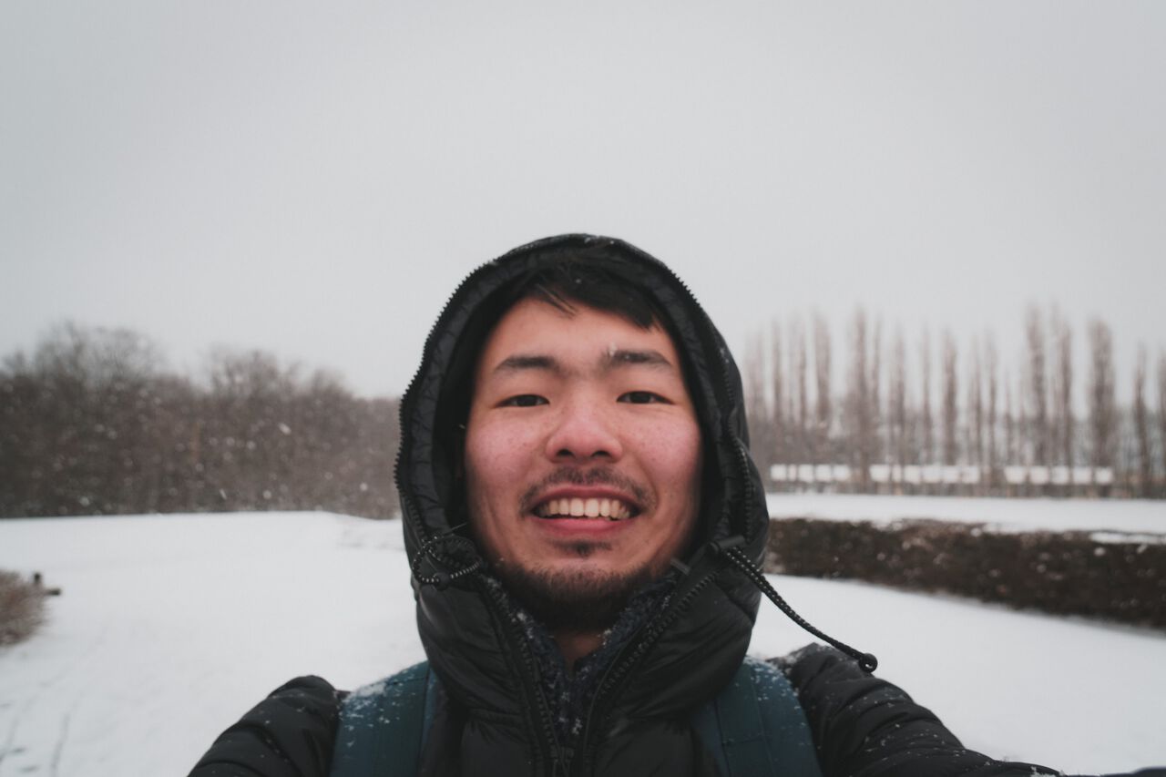 A person wearing a down jacket in a snow in Gdansk, Poland