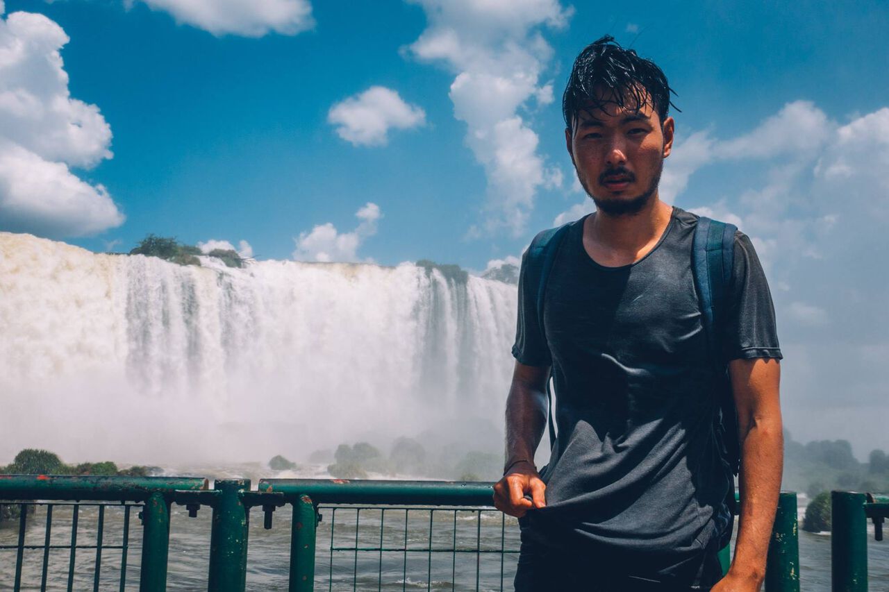 A person wearing breathable shirt soaked wet at the Iguazu Falls in Brazil, South America