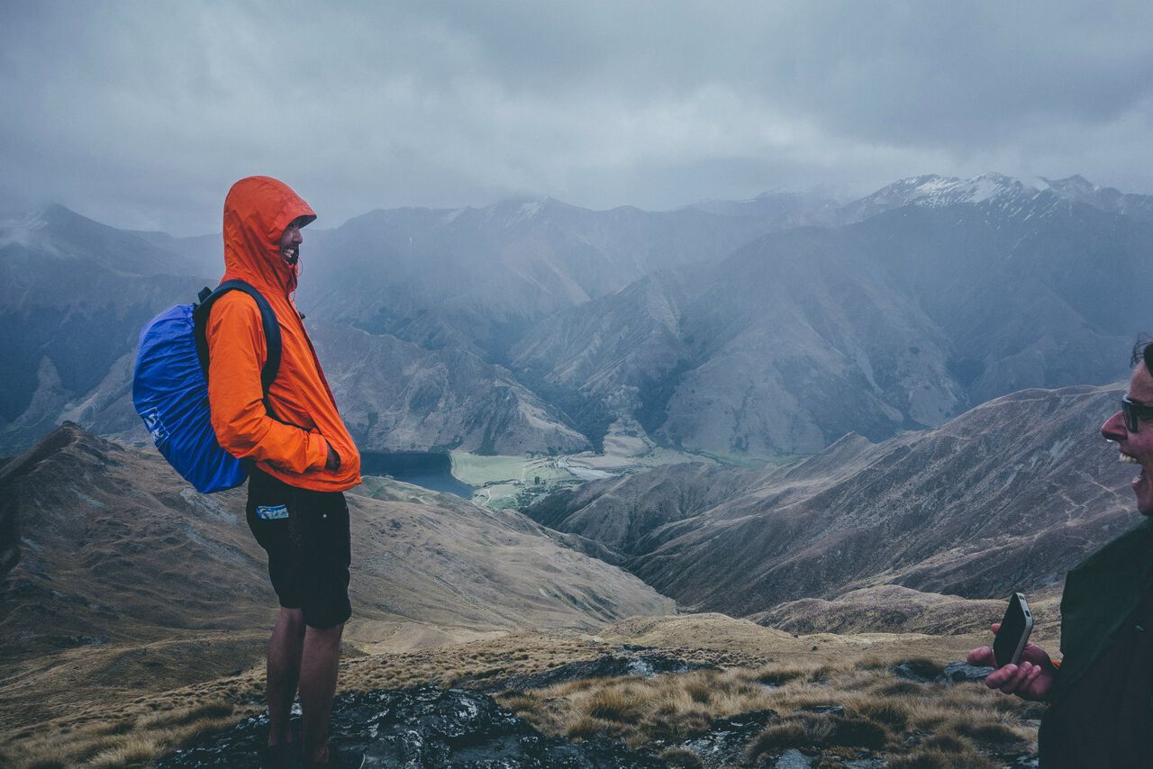 A person wearing a waterproof outer shell in the rain on top of Ben Lomond Mountain in New Zealand