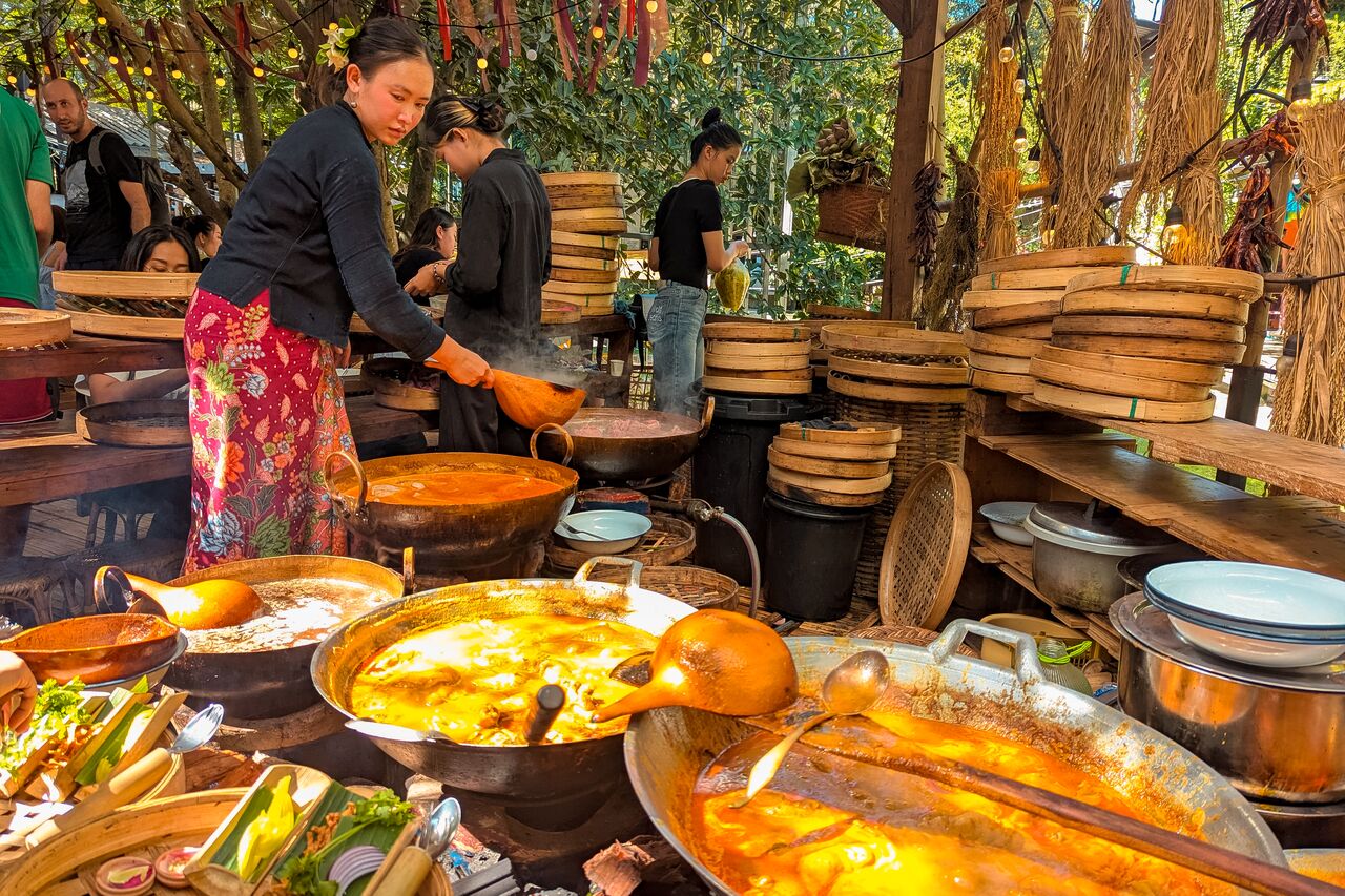 A woman making Khao Soi at Baan Kang Wat