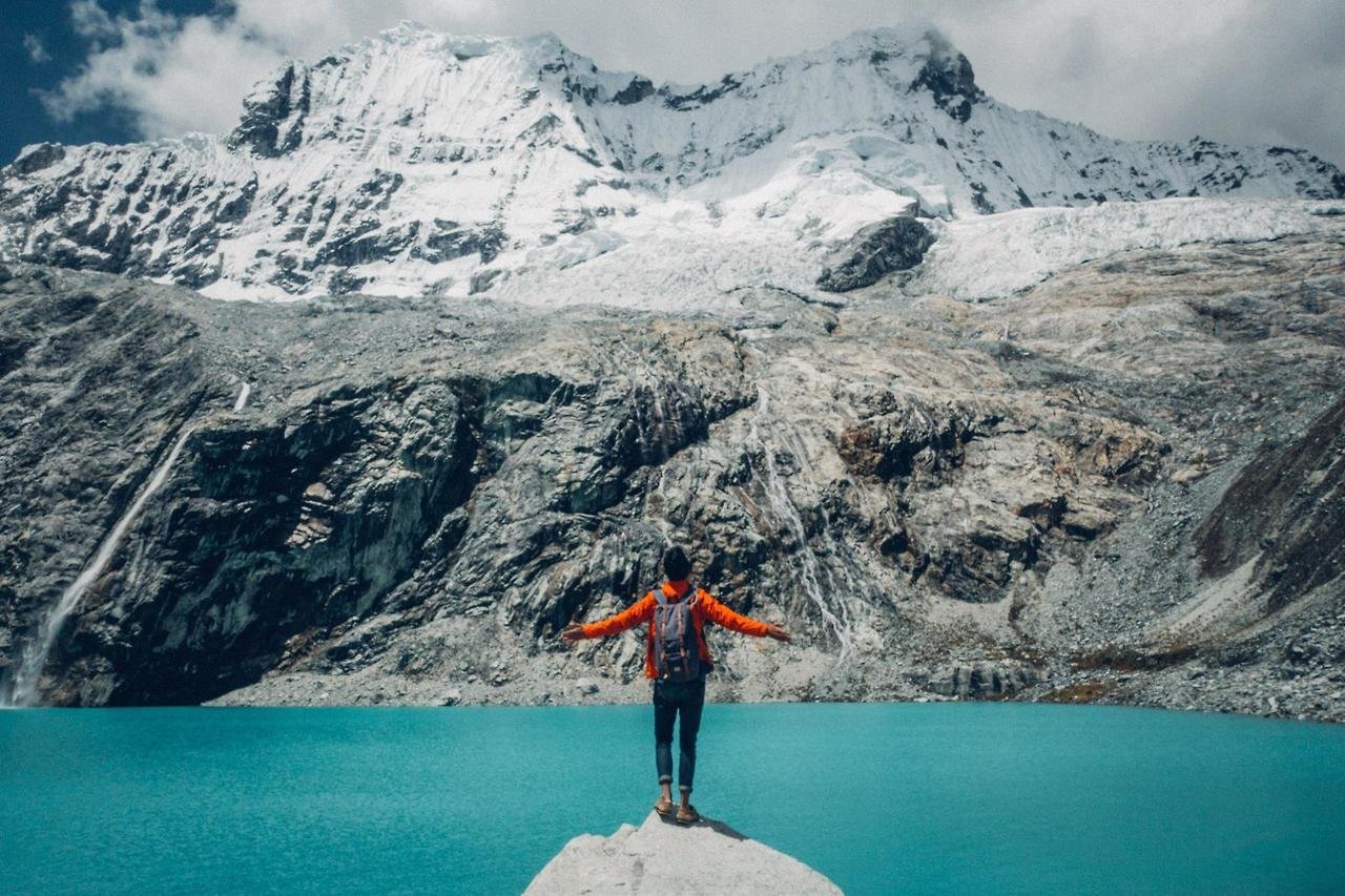 A person wearing a waterproof outer shell at Laguna 69 in Huaraz, Peru, South America