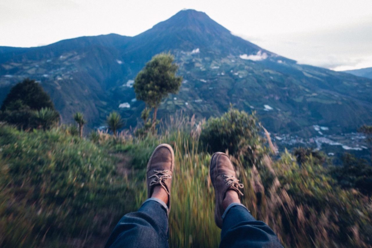 A person legs wearing a travel shoe on a swing in Banos, Ecuador, South America