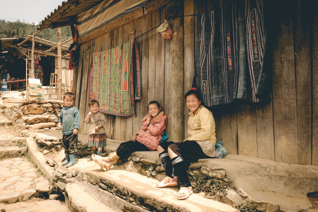 Hmong children smiling at Cat Cat Village in Sapa