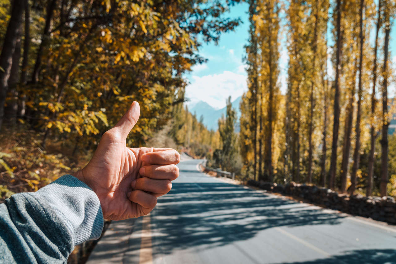 A person sticking out his thumb hitchhiking in Pakistan