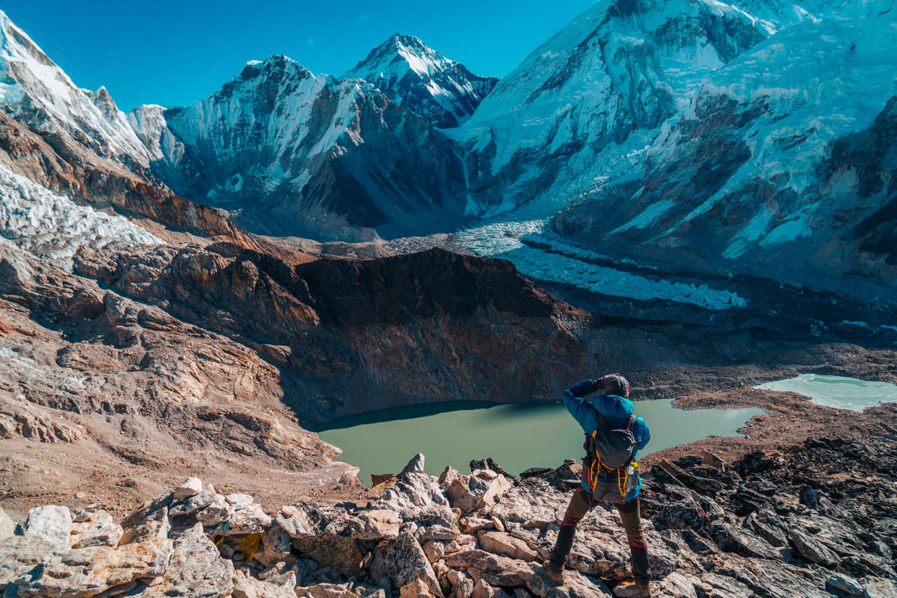 A person with a daypack taking photos at Everest Base Camp, Nepal