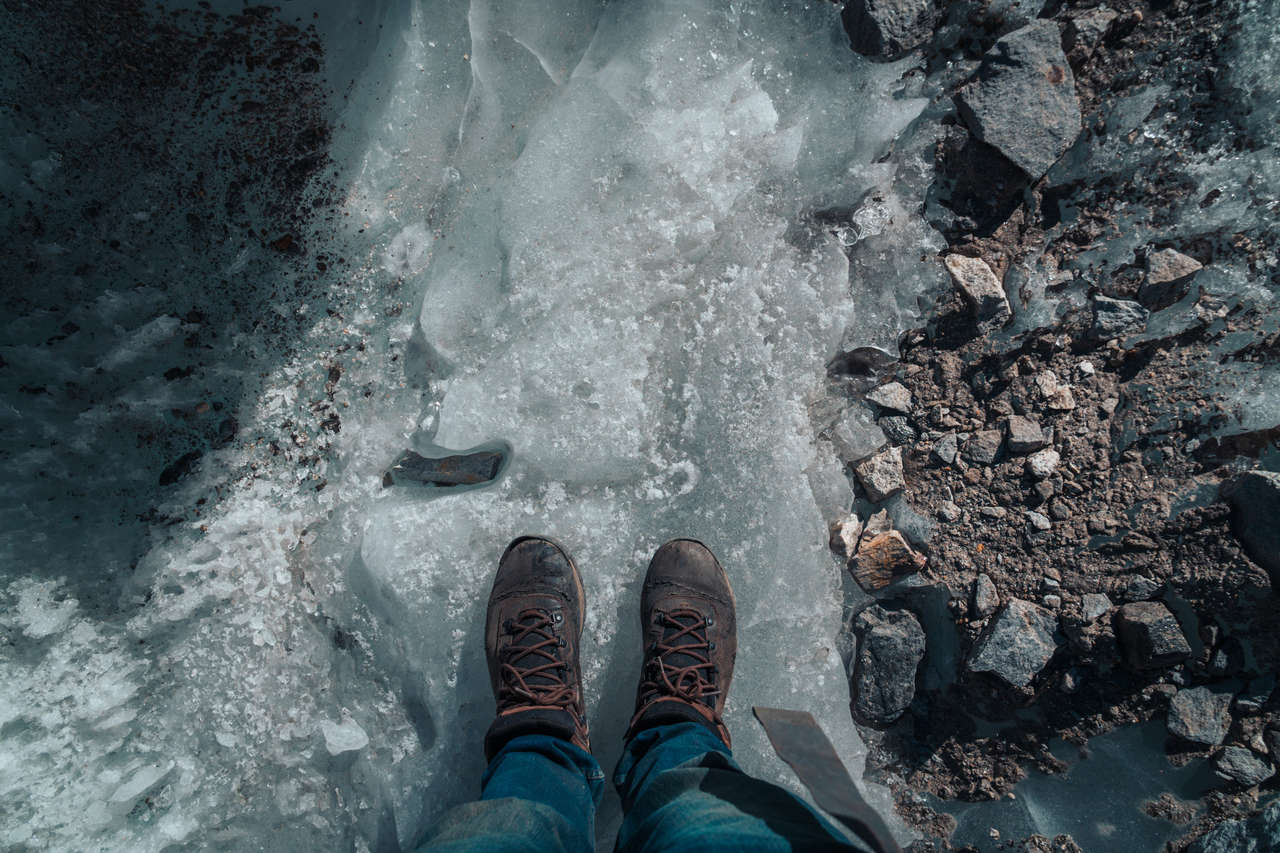 A hiking shoe on icy ground in Nepal