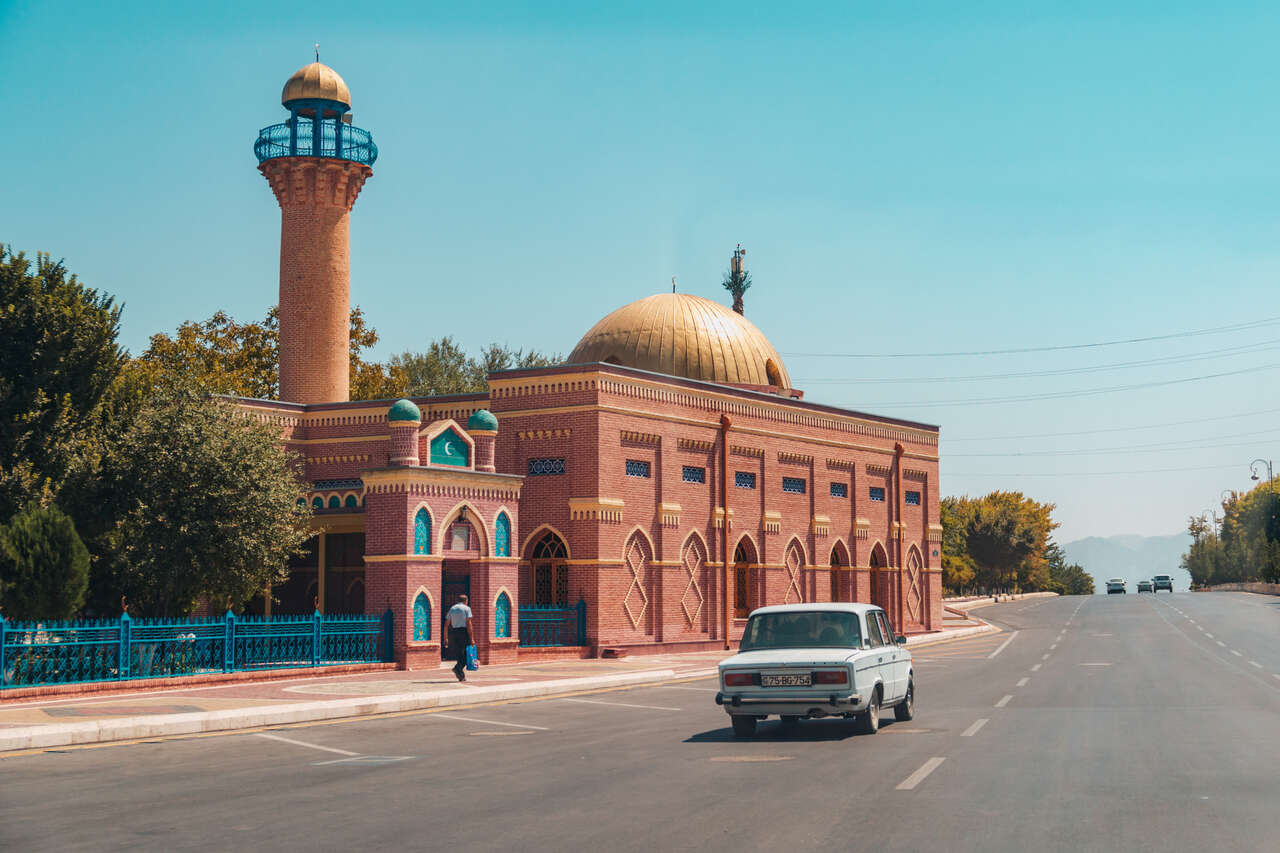 A lada driving passed Juma Mosque in Nakhchivan, Azerbaijan.