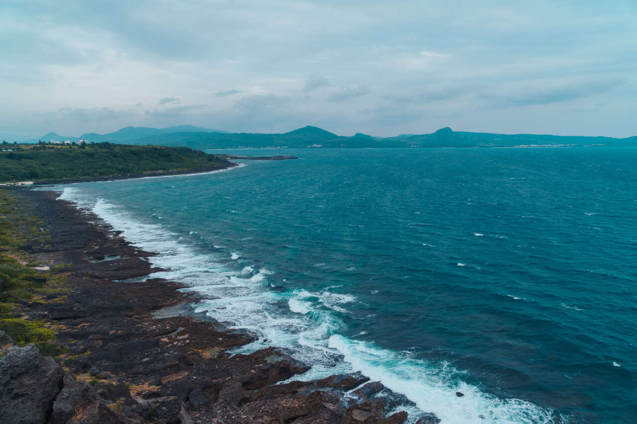 The black limestone reef coastline at Maobitou Park in Kenting, Taiwan.