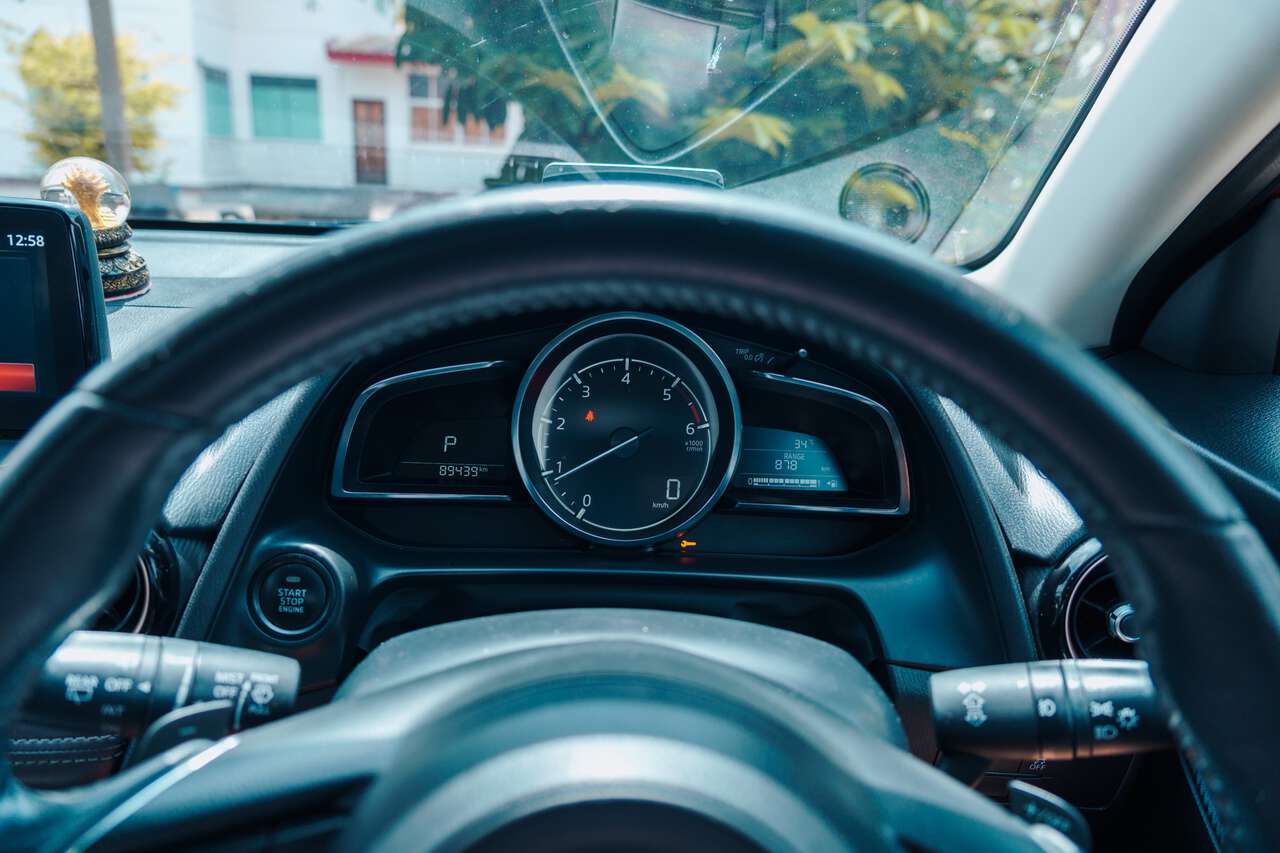 The dashboard of a Mazda 2 car rented from Lopburi