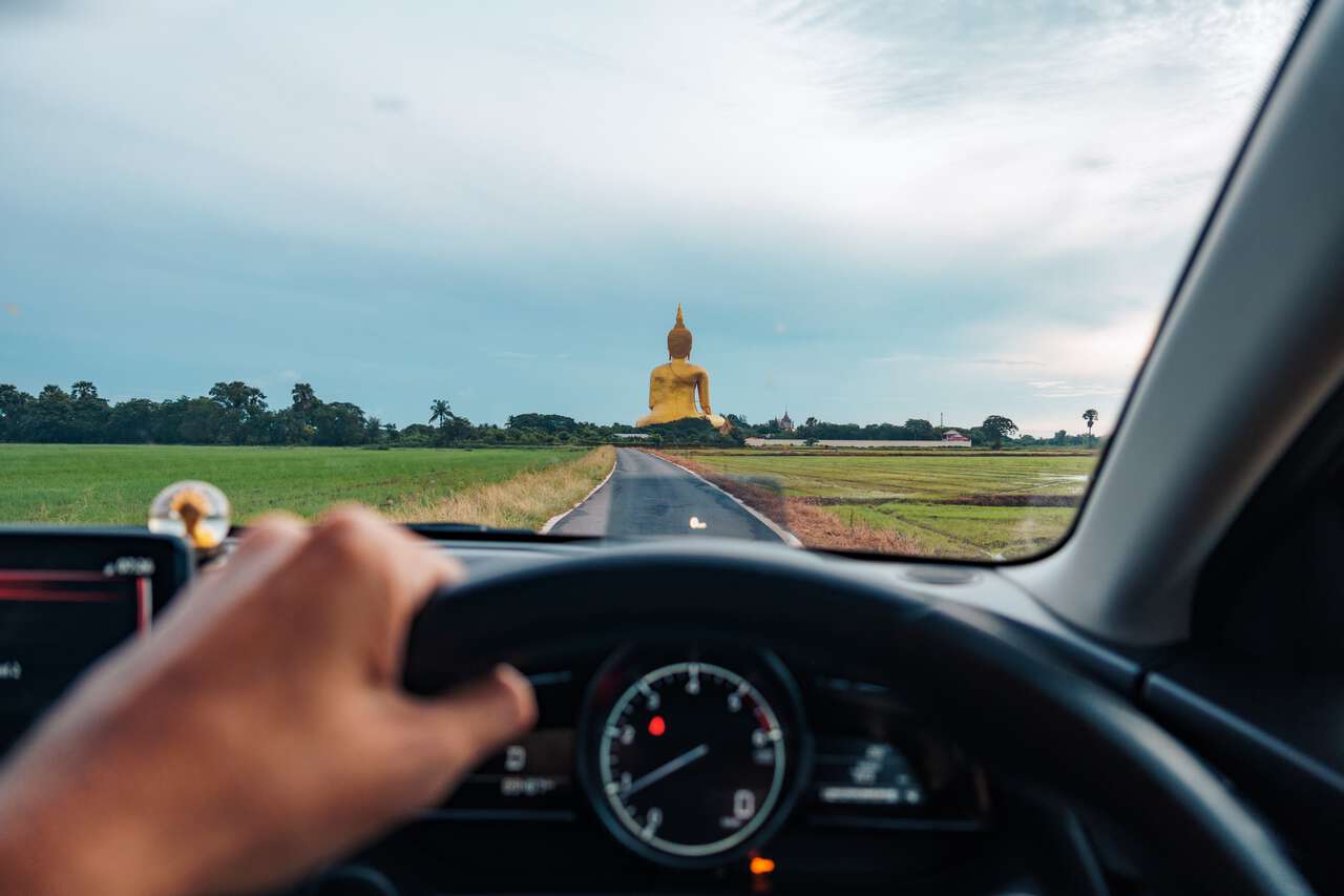 A driver driving towards the Great Buddha of Thailand in Ang Thong