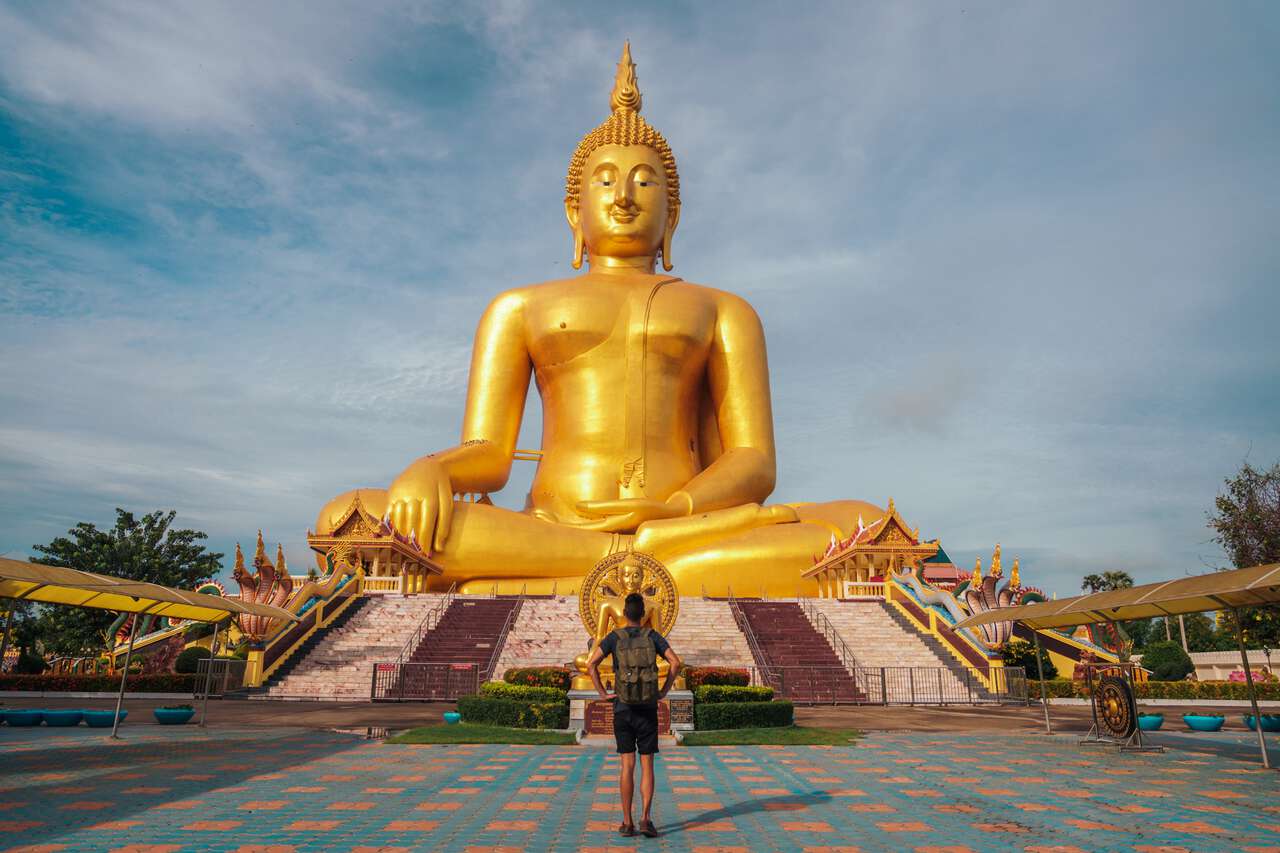 A traveler standing in front of The Great Buddha of Thailand in Ang Thong