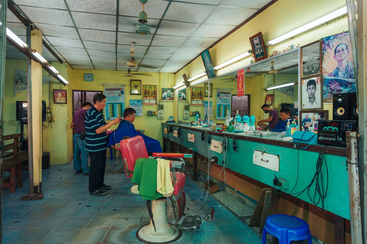 An old-school Thai-style barber at San Chao Rong Thong Vintage Market in Ang Thong