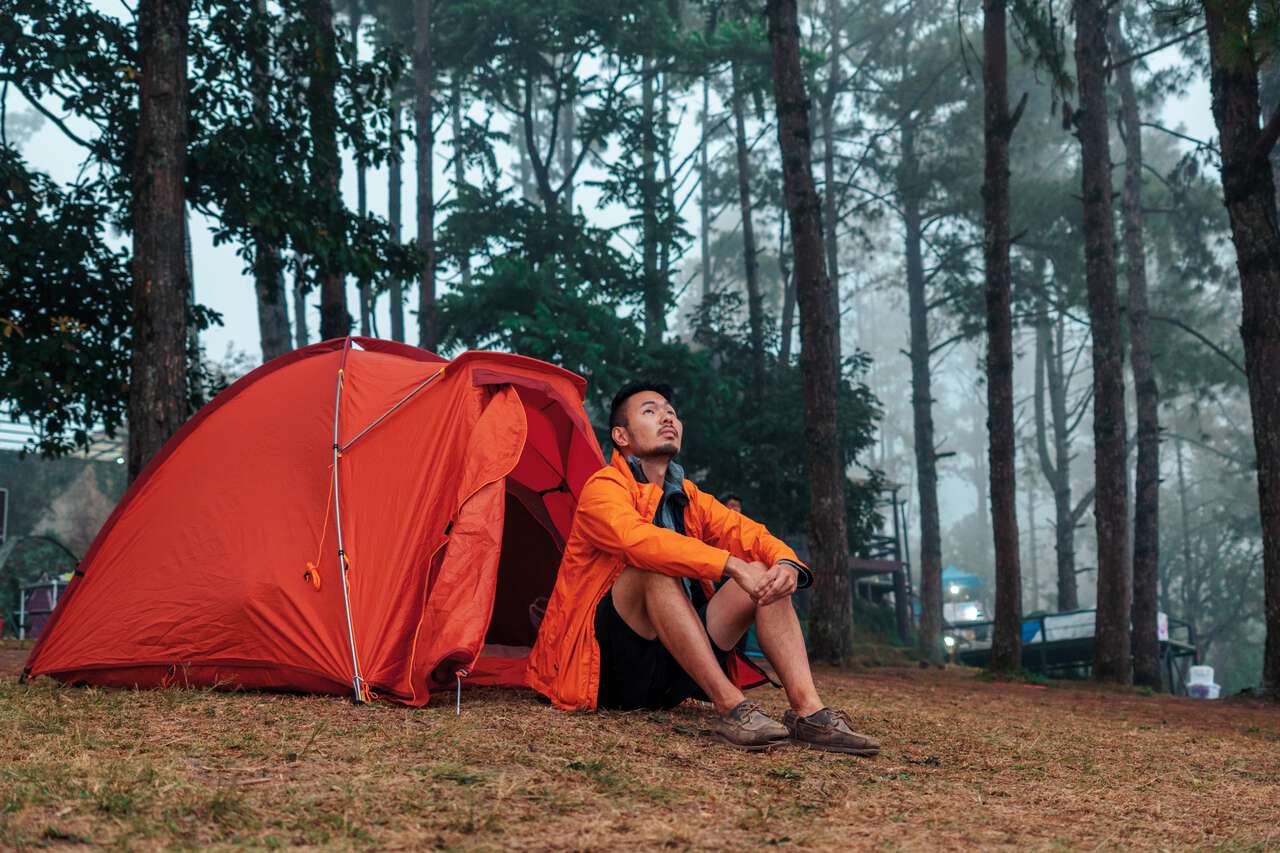 A person siting in front of a tent at Doi Ang Khang in Chiang Mai