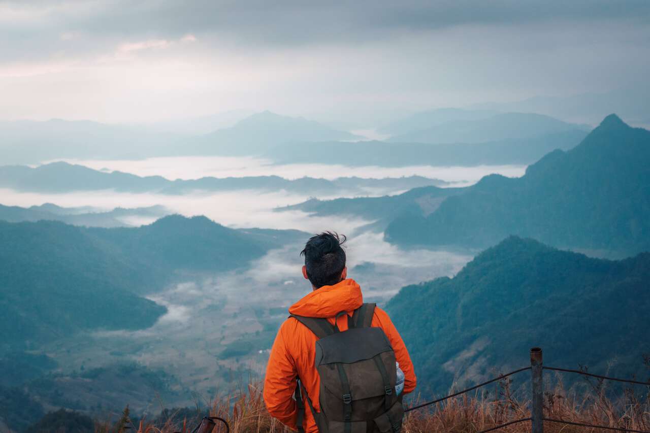 A person looking at the view from the top of Phu Chi Fa in Chiang Rai