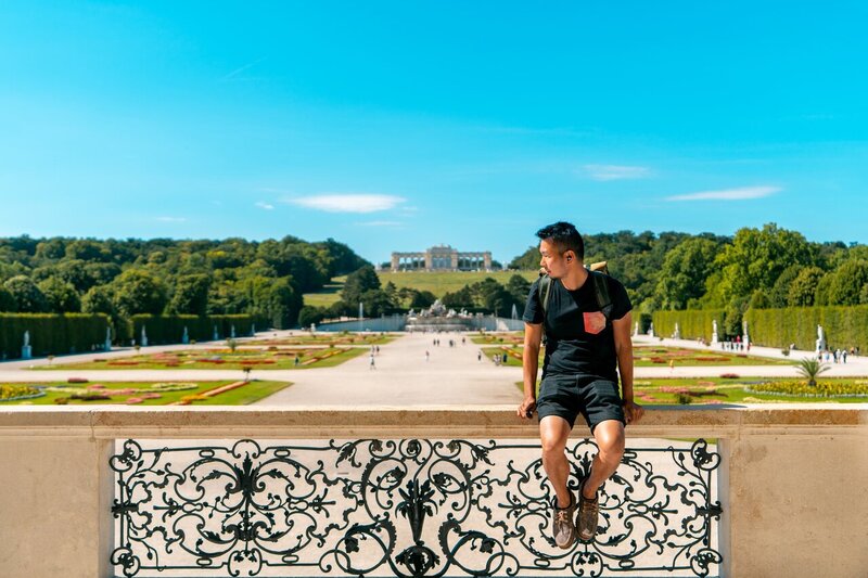 A person sitting on a balcony at Schonbrunn Palace in Vienna