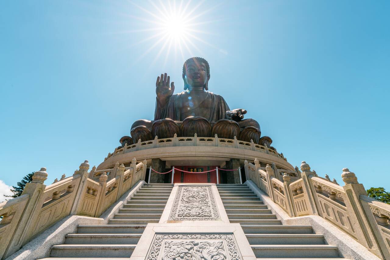 Tian Tan Buddha with the sun above it