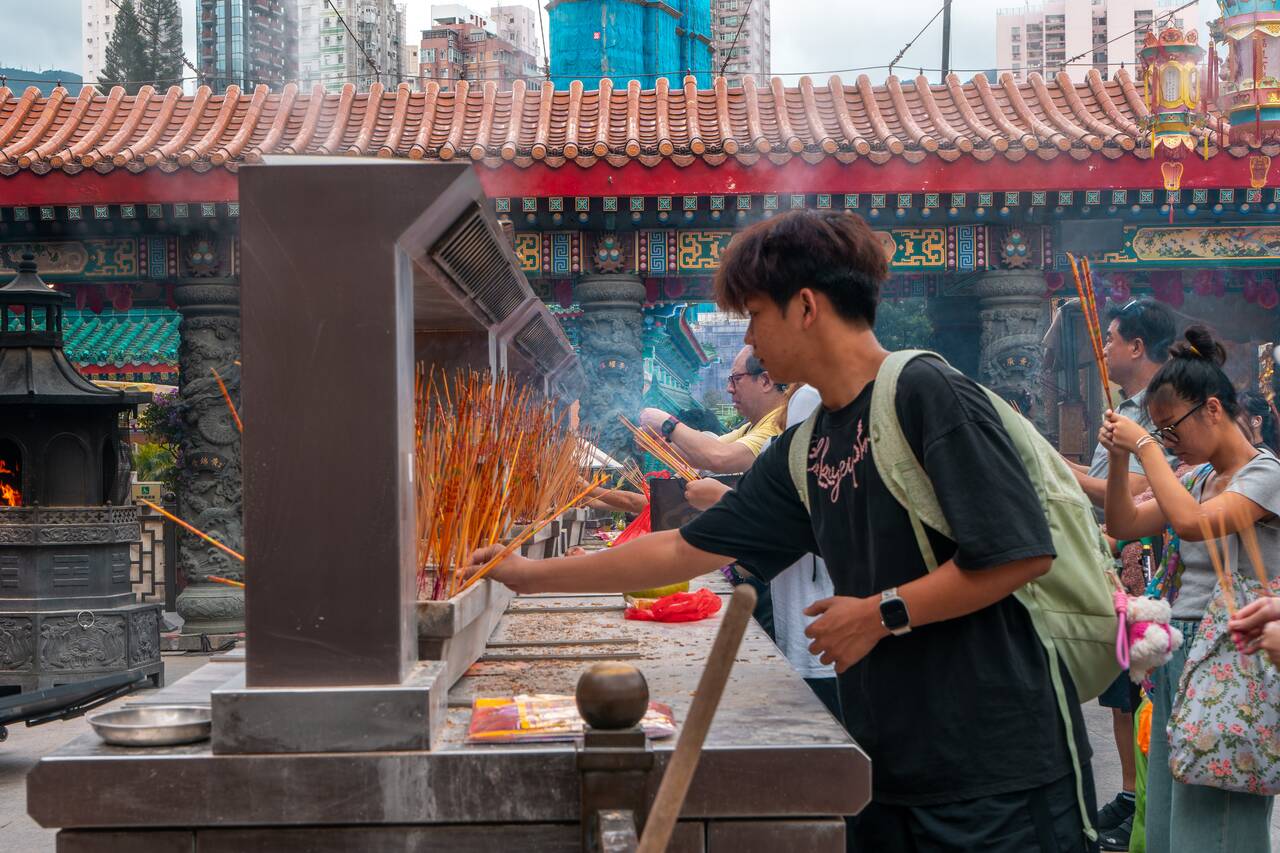 People with incense at Sik Sik Yuen Wong Tai Sin Temple