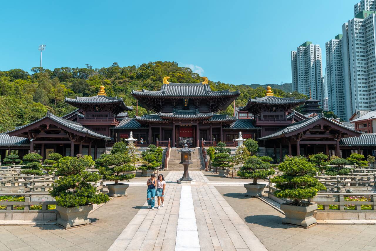 2 people walking away from the temple at Nan Lian Garden