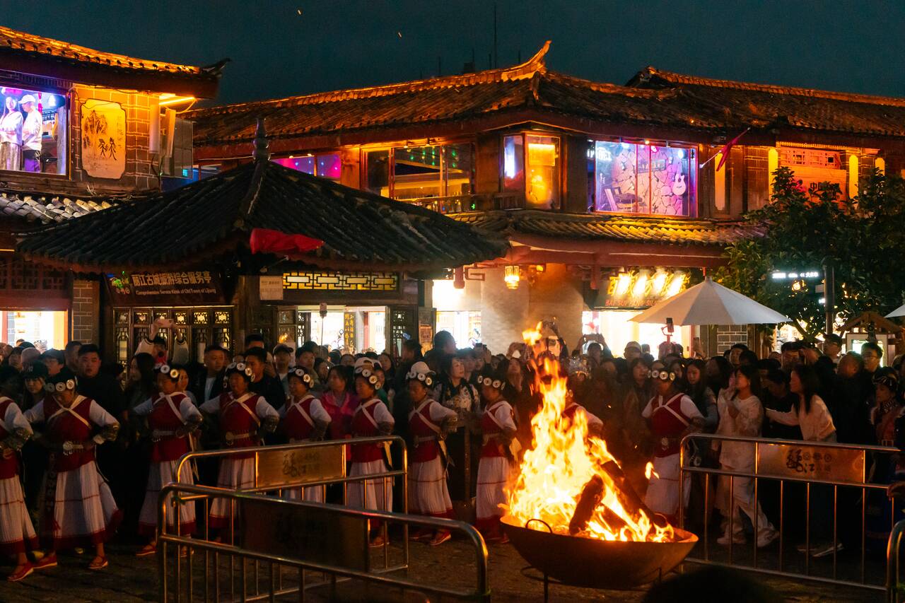 Locals dancing by a bonfire at Sifang Street Square
