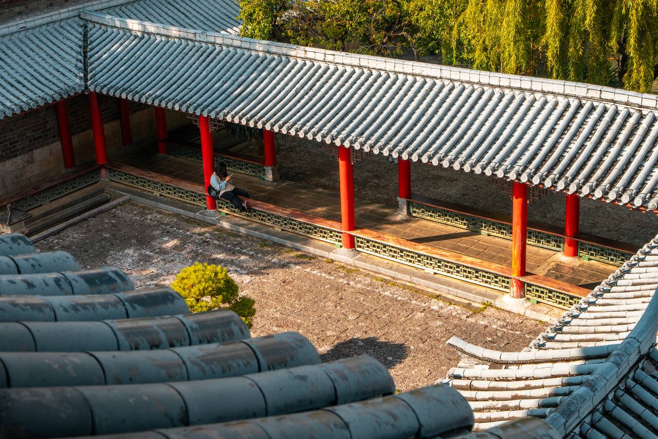 A person reading at Mu Fu Mansion