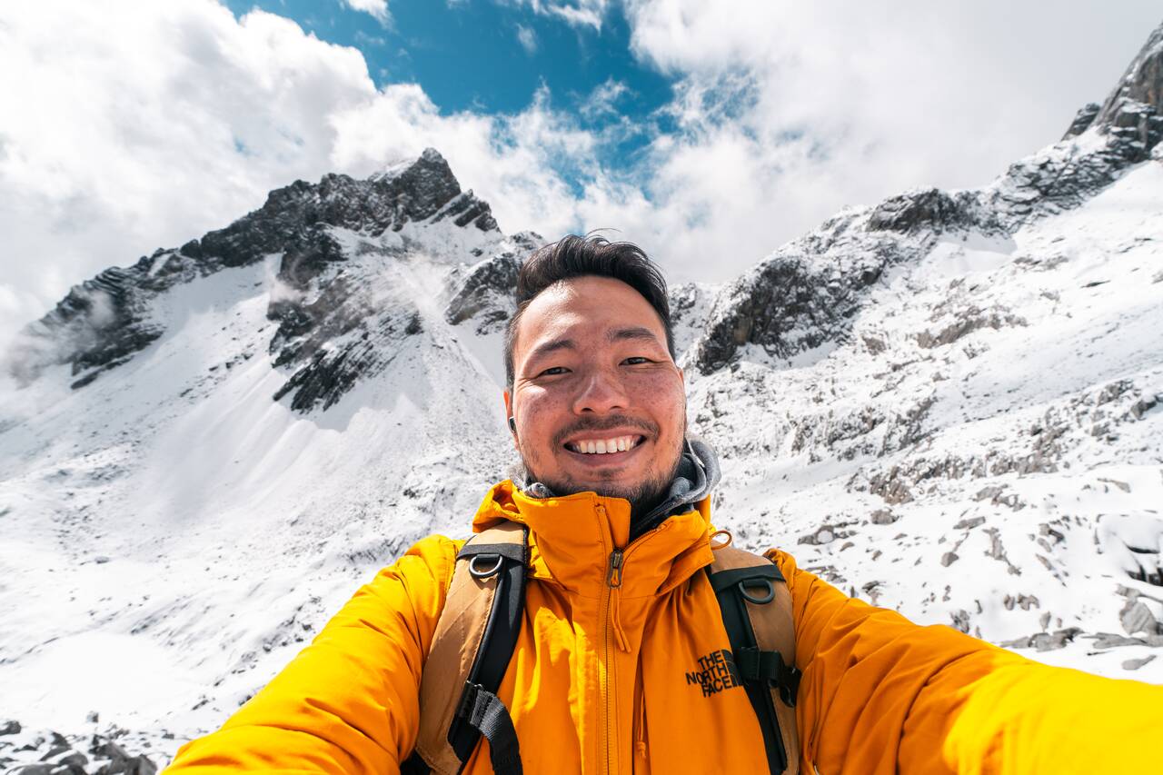 Me smiling at Yulong Snow Mountain