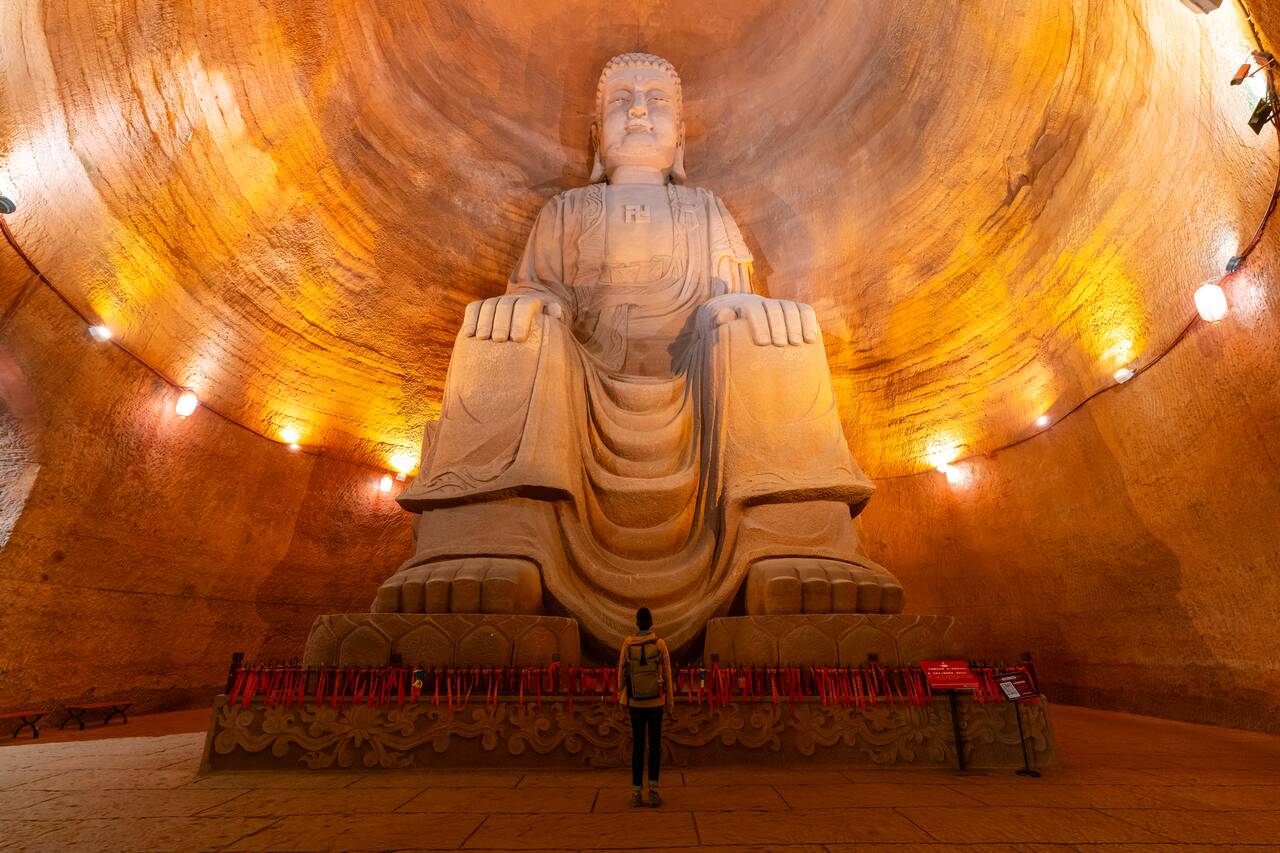 Me looking at a giant buddha statue at Oriental Buddha Park