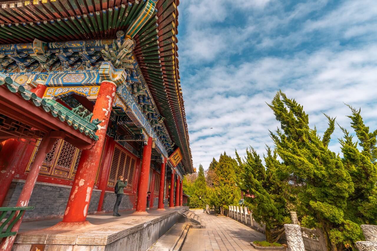 A person taking a photo at Tianmen Temple