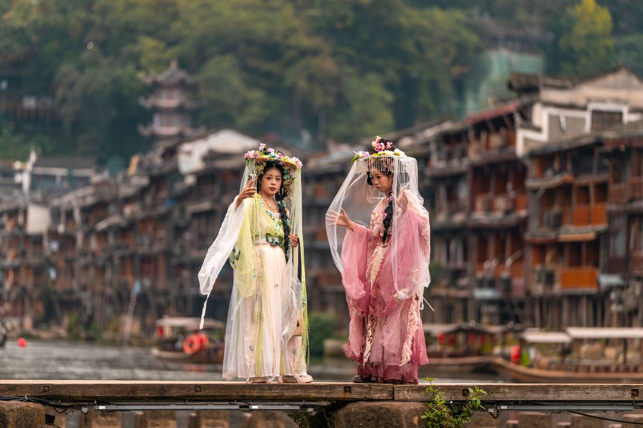 Women taking photos at Tuojiang Stepping Stone