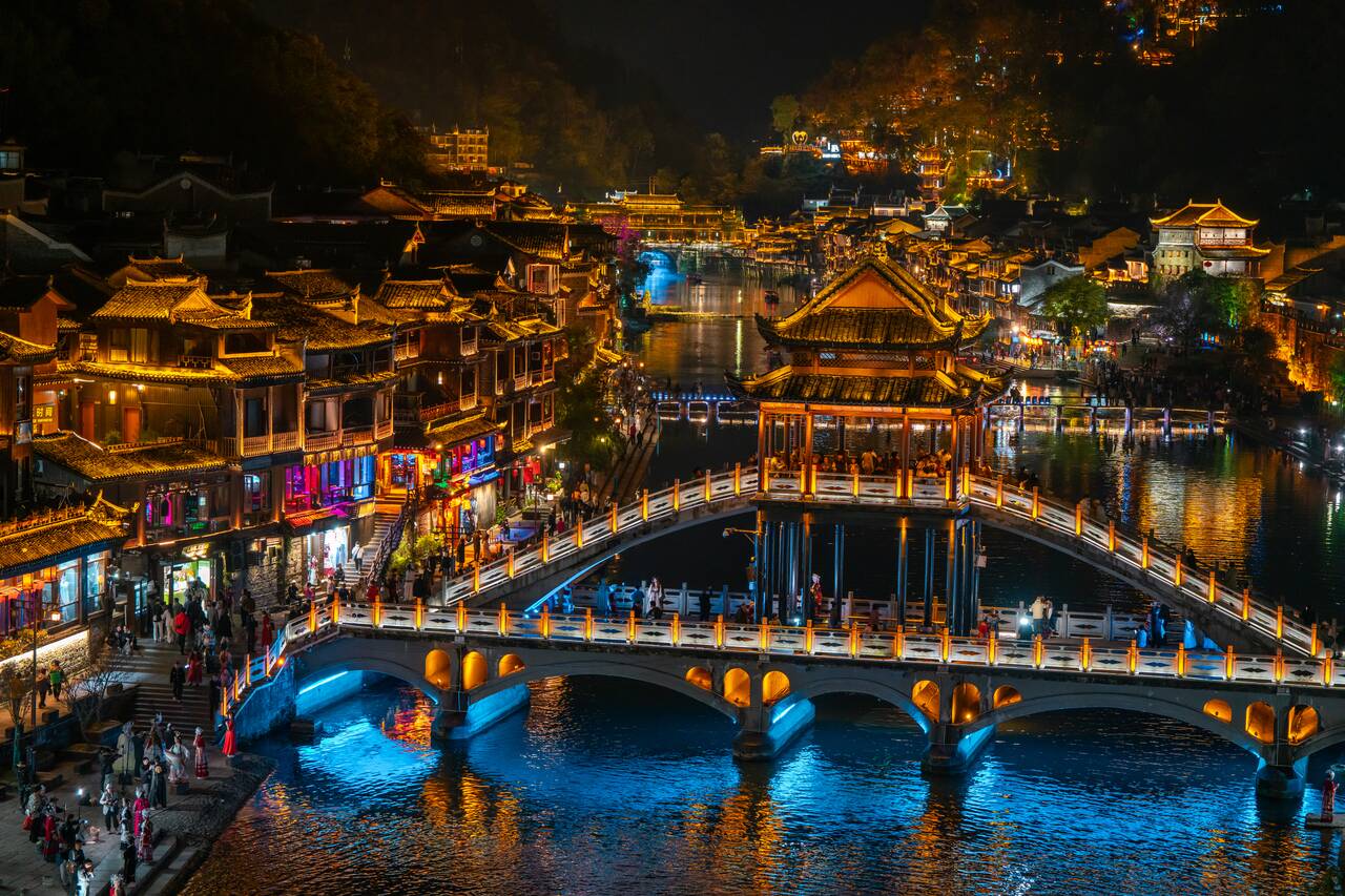 The Snow Bridge and the Fenghuan Town behind at night with lights
