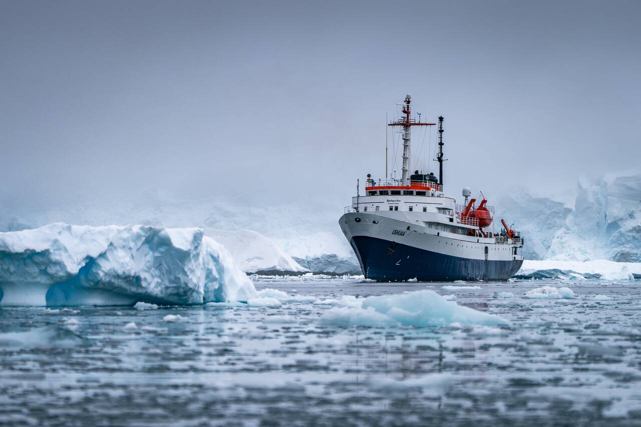 Ushuaia ship surrounded by Ice Bergs in Antarctica