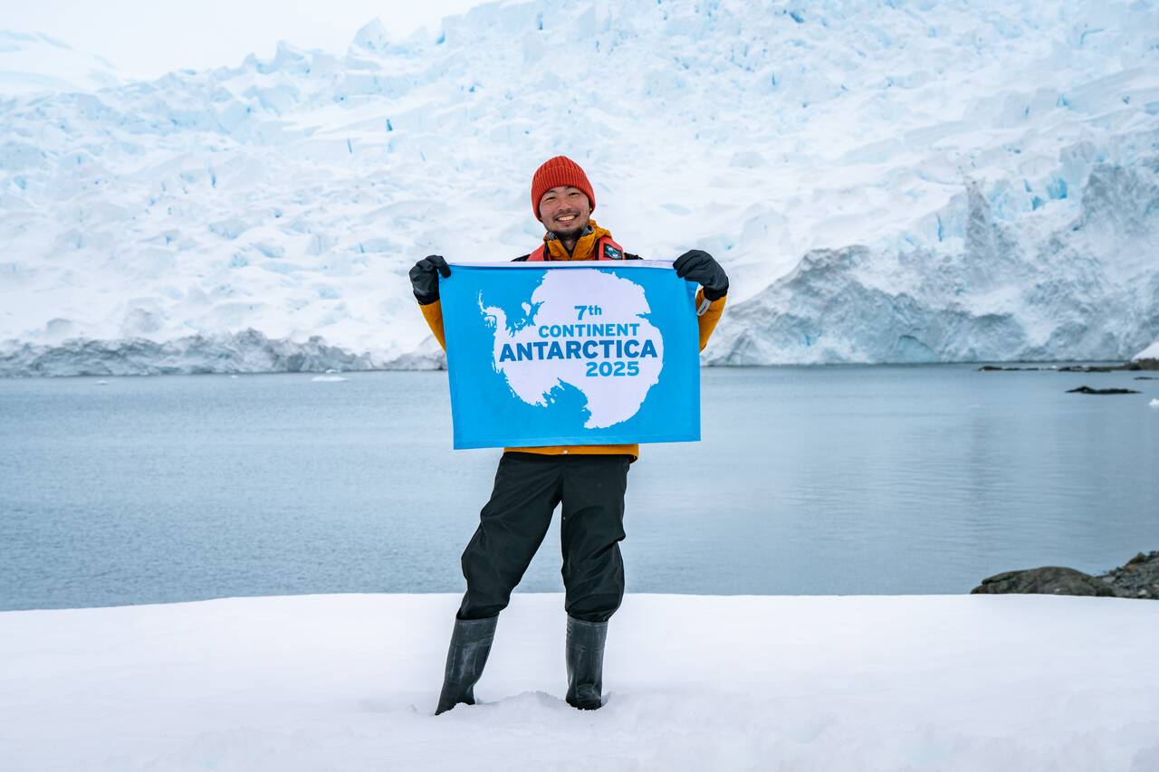 Me holding the Antarctica flag in Antarctica