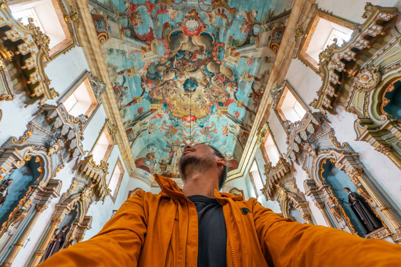Me looking up at the ceiling of Igreja de São Francisco de Assis