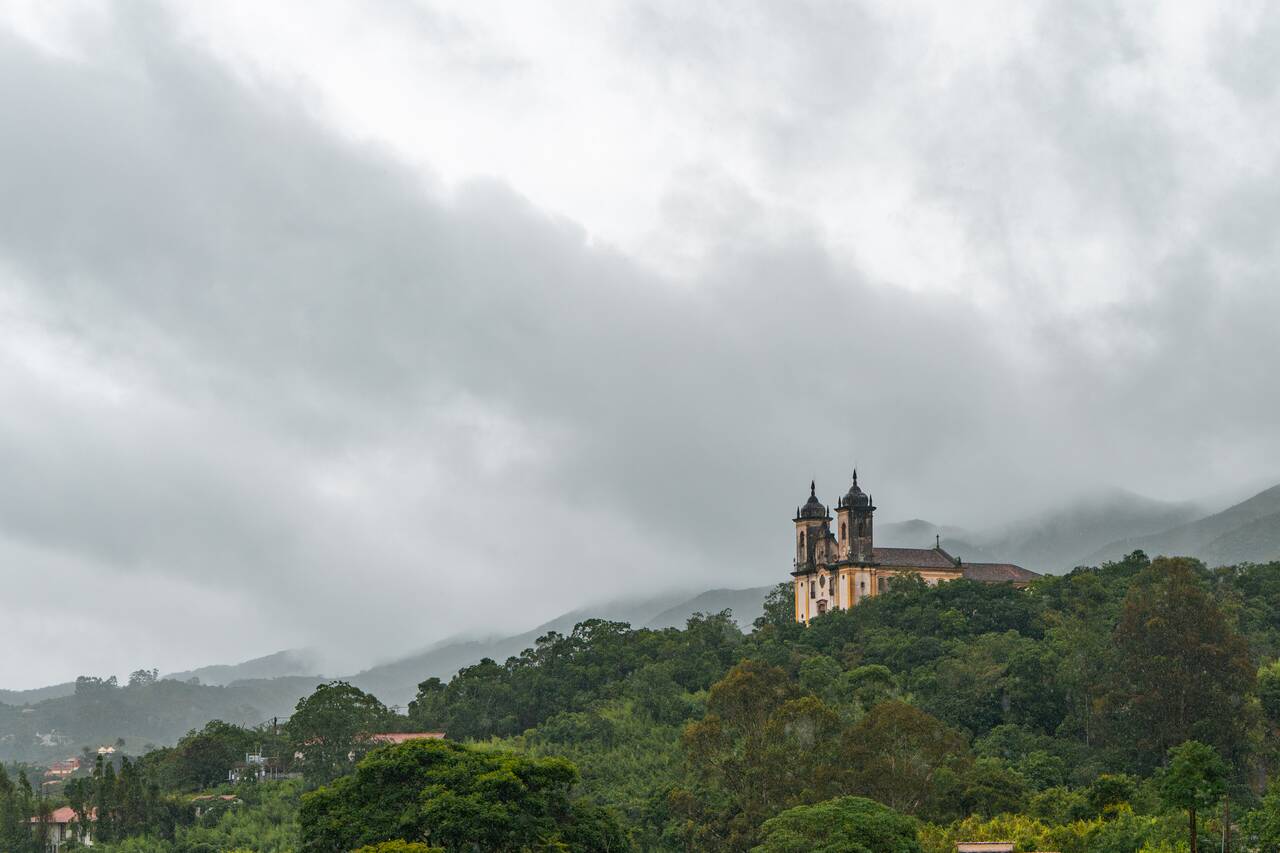 A church on a hill on a rainy day in Ouro Preto