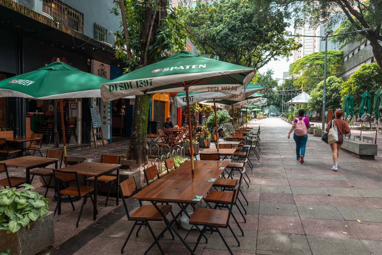 People walking by a cafe at Savassi