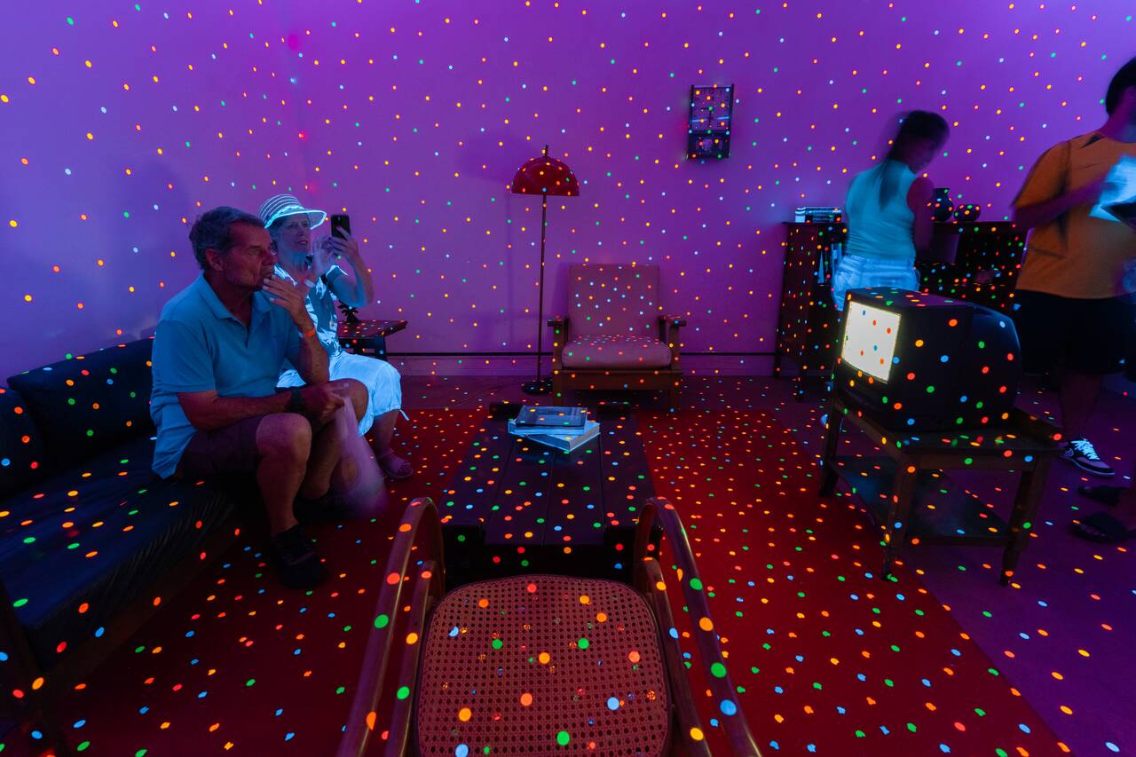 People taking photos inside the polka dot room at Yayoi Kusama Gallery