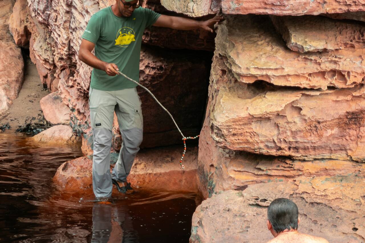 A local guide moving a snake at Riachinho